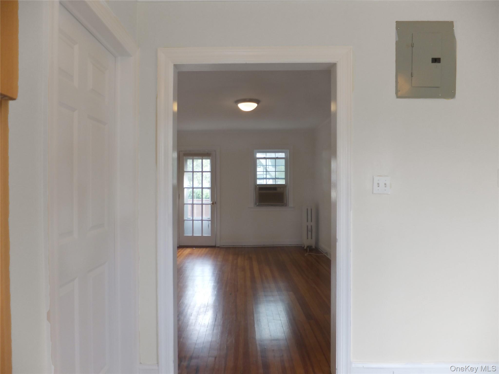 107 Kensington Road, Unit 5 Bronxville, NY 10708 - Photo 9 of 17 Hallway with electric panel, hardwood / wood-style floors, and radiator