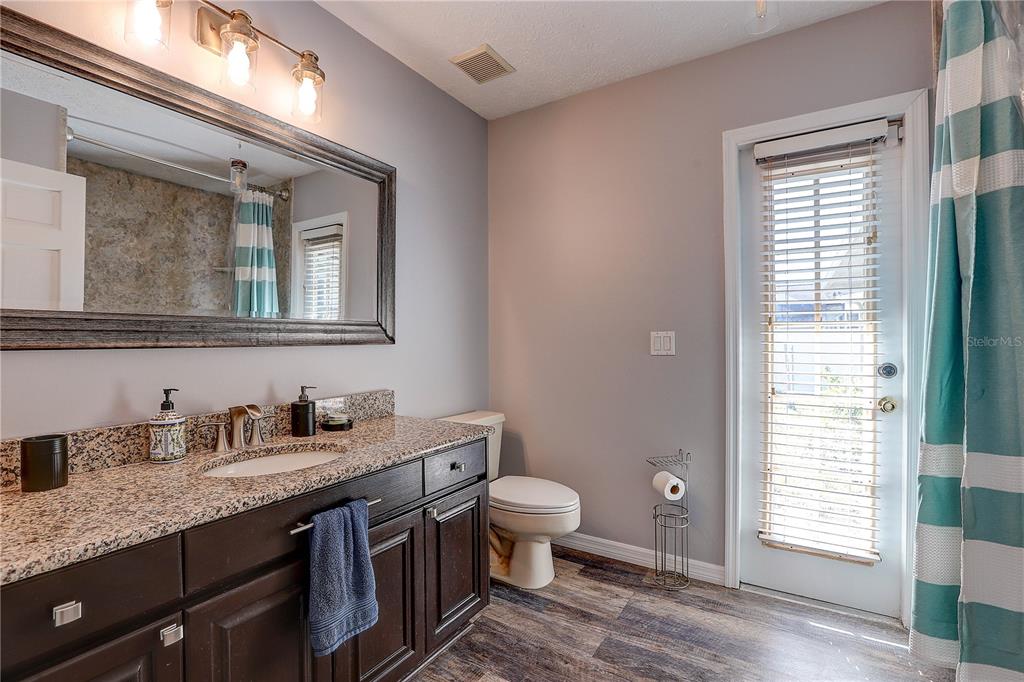 1418 Buckner Road Valrico, FL 33596 - Photo 24 of 37 a bathroom with a granite countertop toilet sink and mirror