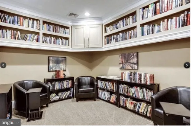 a reading room with furniture book shelf and a book shelf