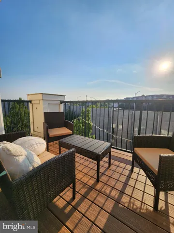 a view of a patio with wooden chairs