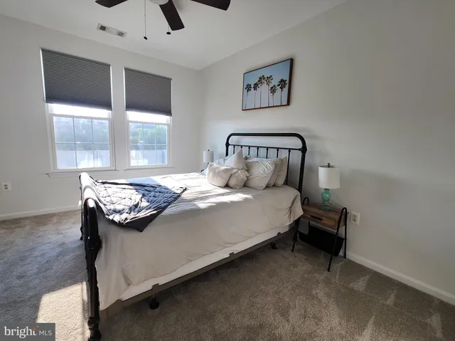 a bed room with a bed and painting on the wall