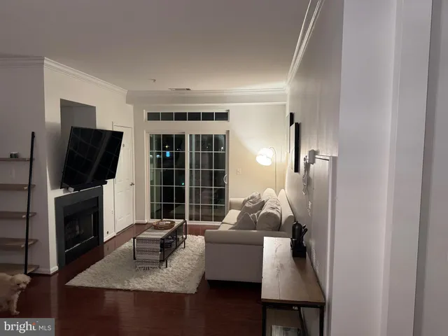 a spacious bedroom with a bed a window and a ceiling fan