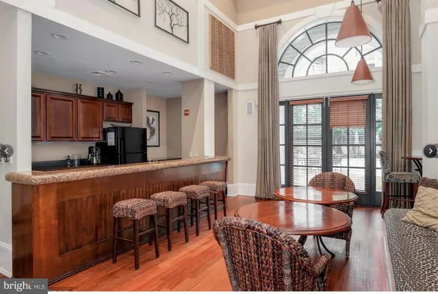 a dining room with furniture a window and a chandelier