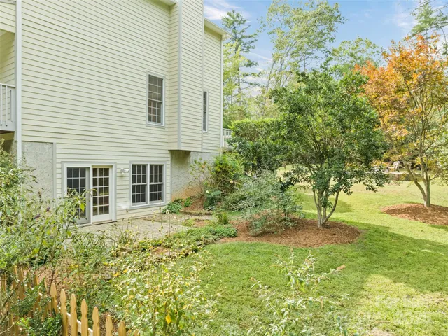 a view of backyard of house with green space