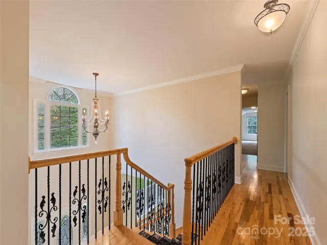 a view of a hallway with wooden floor and fence