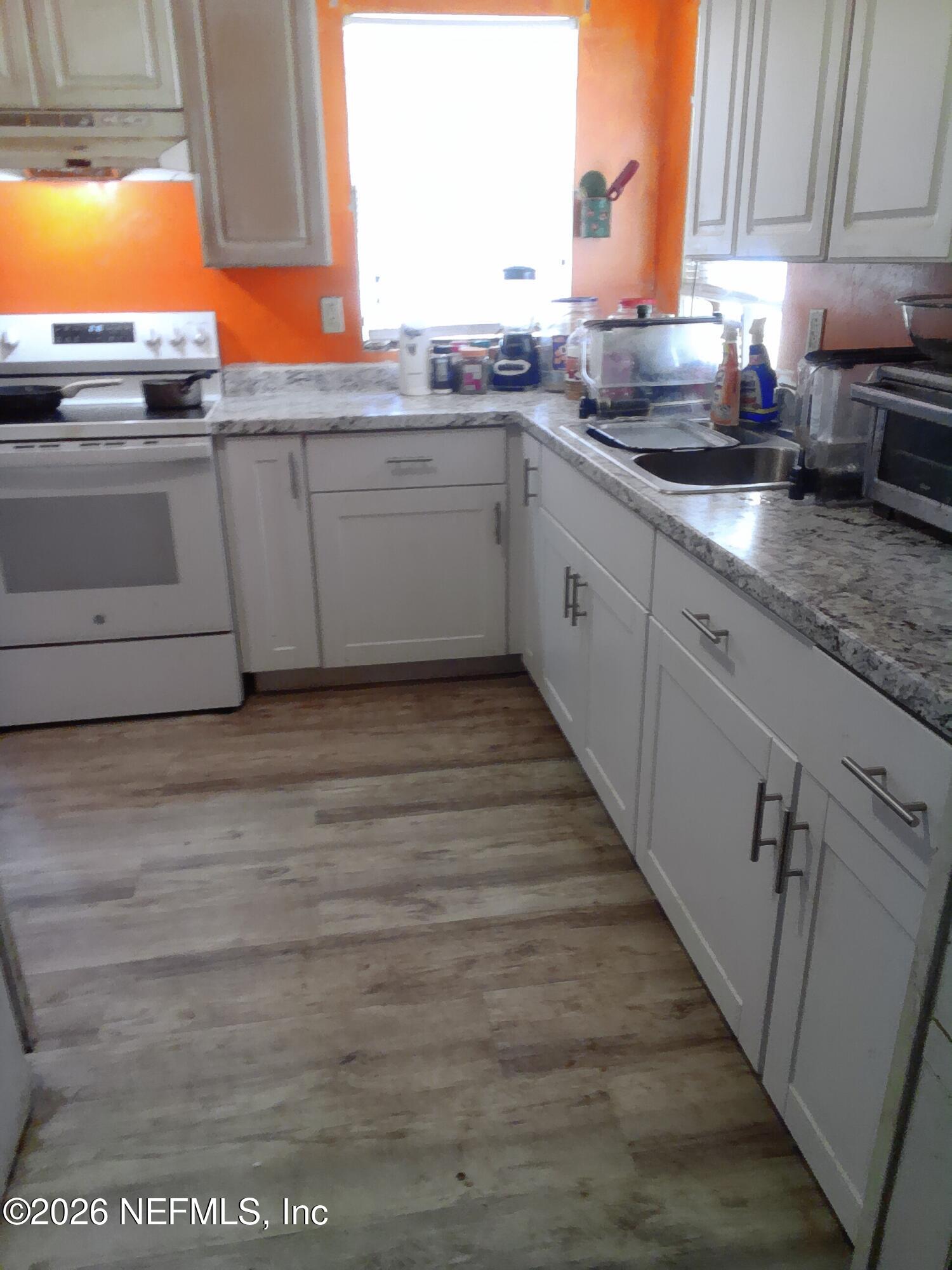 5816 Bryce Street Keystone Heights, FL 32656 - Photo 2 of 5 a kitchen with granite countertop a sink and cabinets