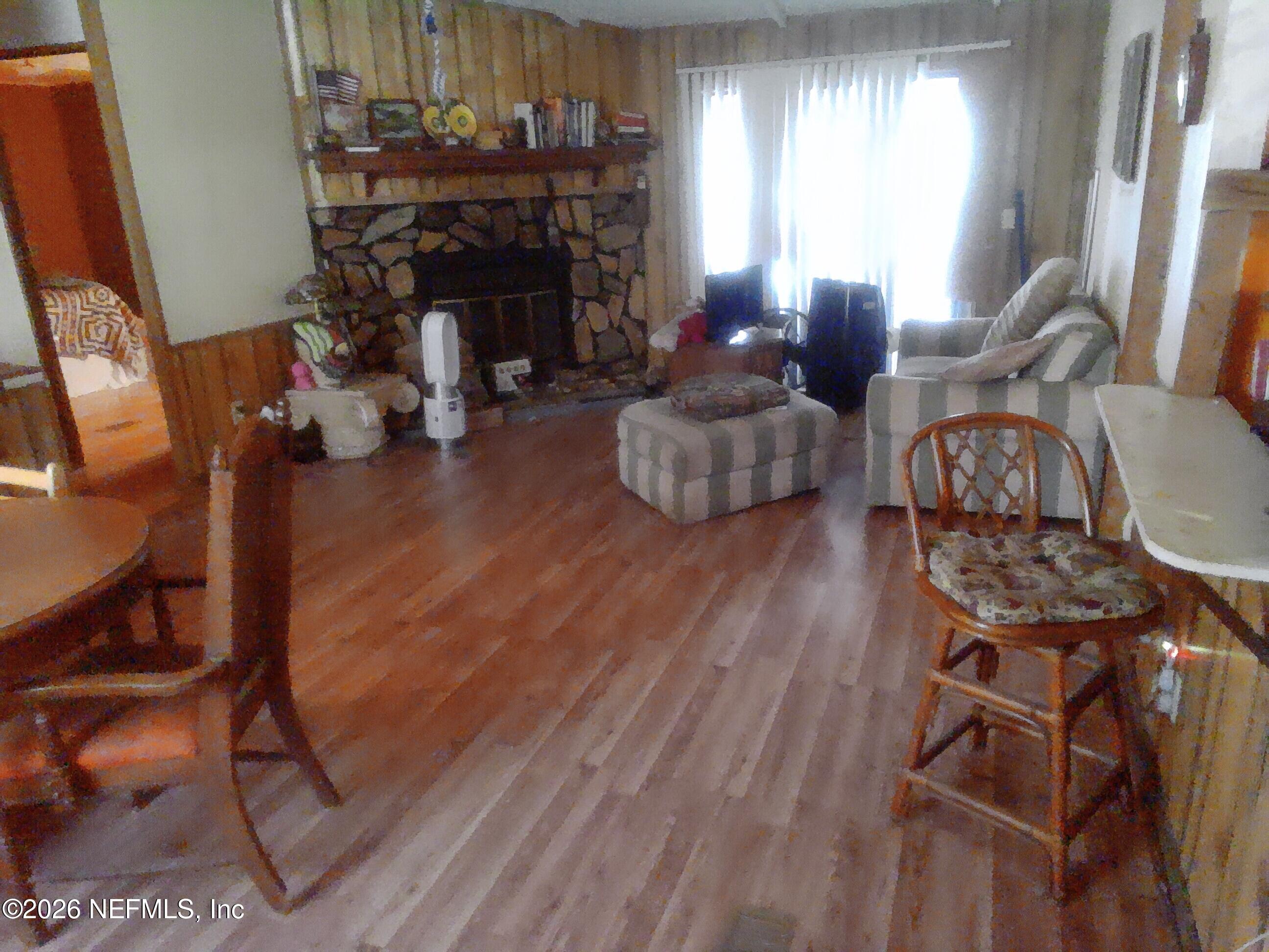 5816 Bryce Street Keystone Heights, FL 32656 - Photo 4 of 5 a living room with furniture a fireplace and window