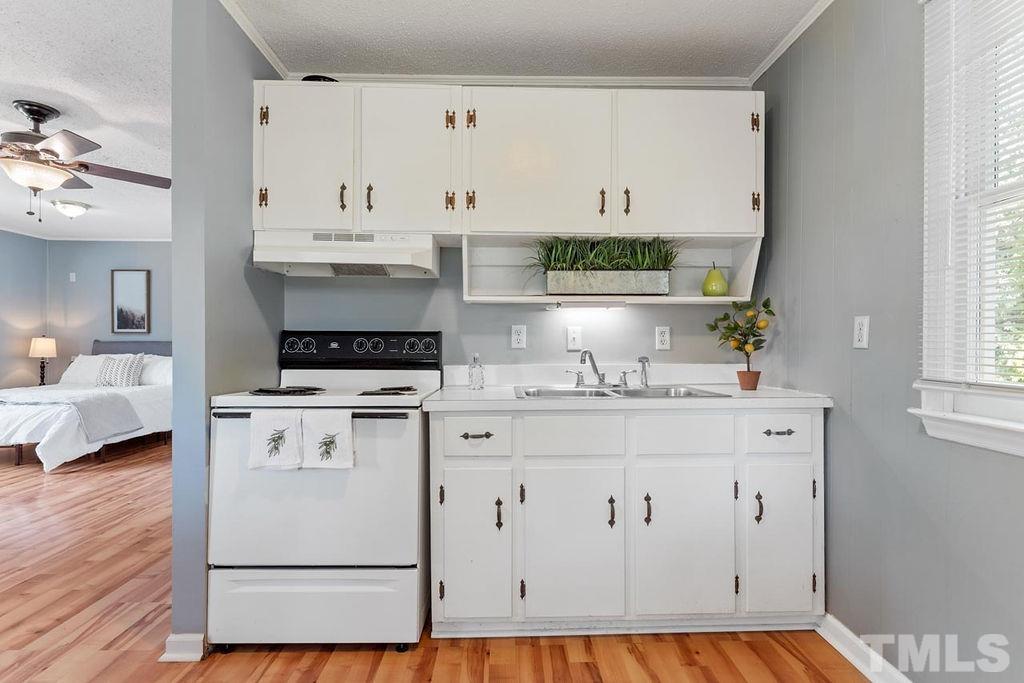 2180 Sanders Road Stem, NC 27581 - Photo 22 of 24 a kitchen with cabinets appliances and a window