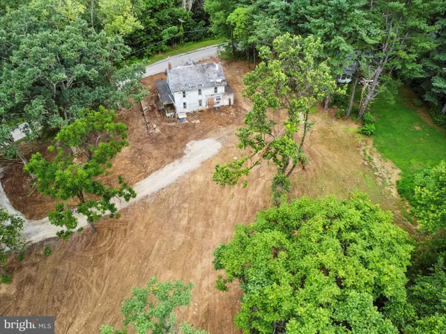 an aerial view of a house with a yard and lake view