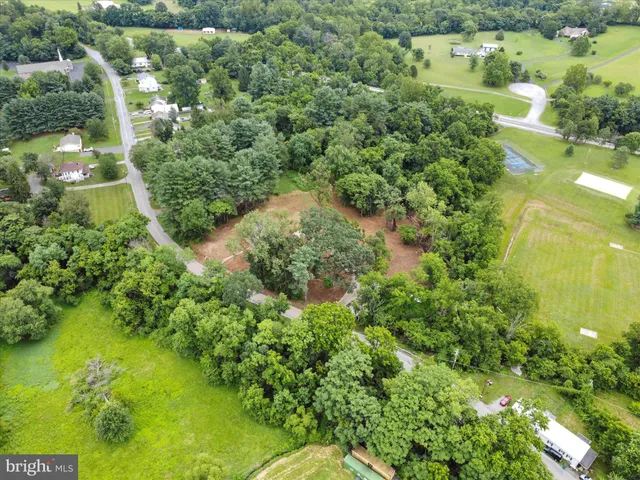 an aerial view of a house with a yard and lake view