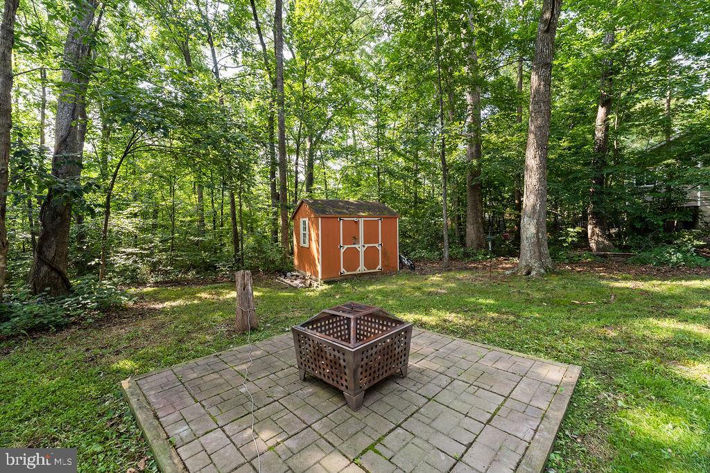 127 Saylers Creek Road Locust Grove, VA 22508 - Photo 16 of 56 a backyard of a house with table and chairs