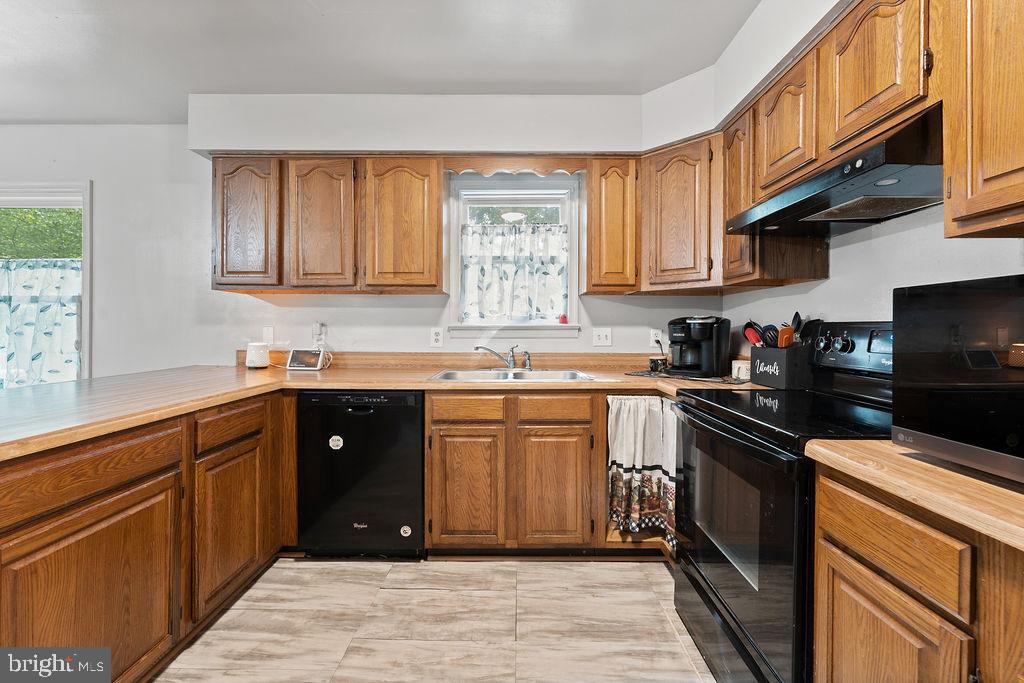 127 Saylers Creek Road Locust Grove, VA 22508 - Photo 37 of 56 a kitchen with stainless steel appliances granite countertop a stove sink and cabinets