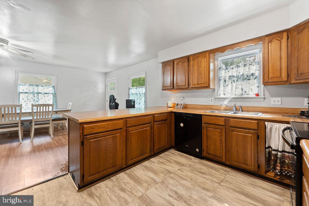 127 Saylers Creek Road Locust Grove, VA 22508 - Photo 38 of 56 a kitchen with stainless steel appliances granite countertop a stove a sink dishwasher and cabinets with wooden floor