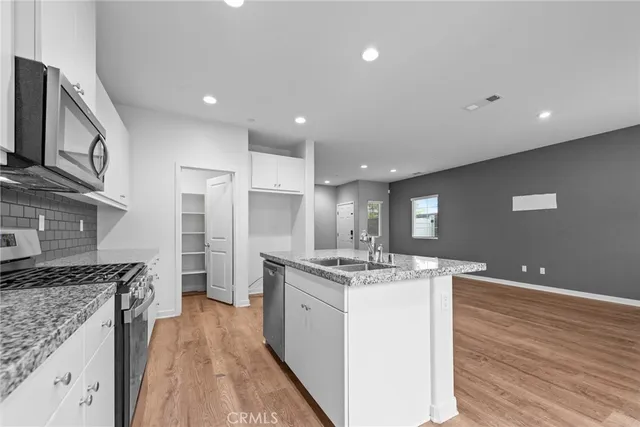 a kitchen with a sink stove and refrigerator