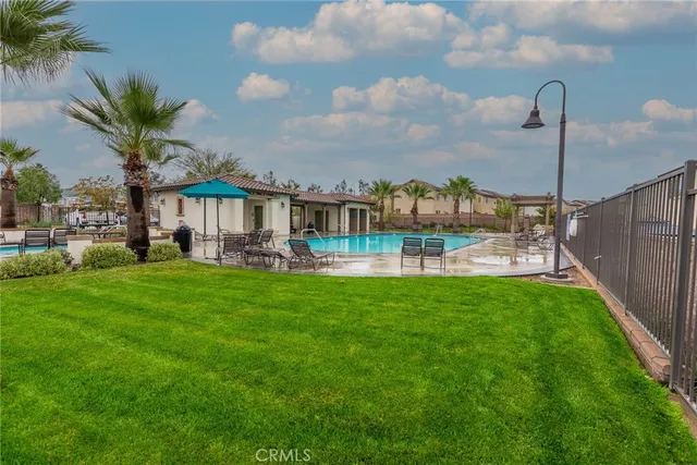 a front view of house with a garden and lake view