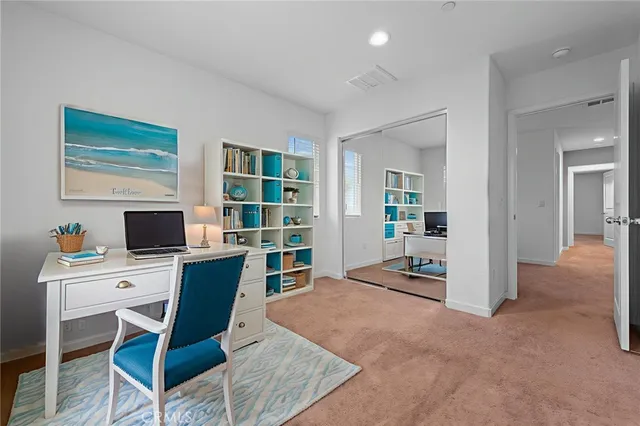 a work room with furniture and a flat screen tv