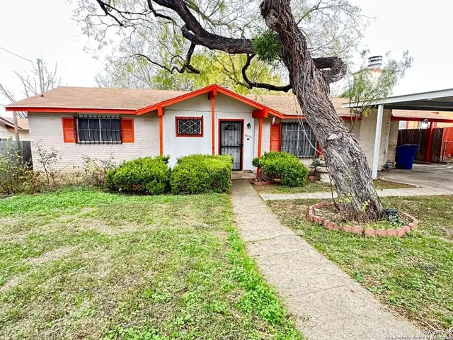 a front view of a house with yard and green space