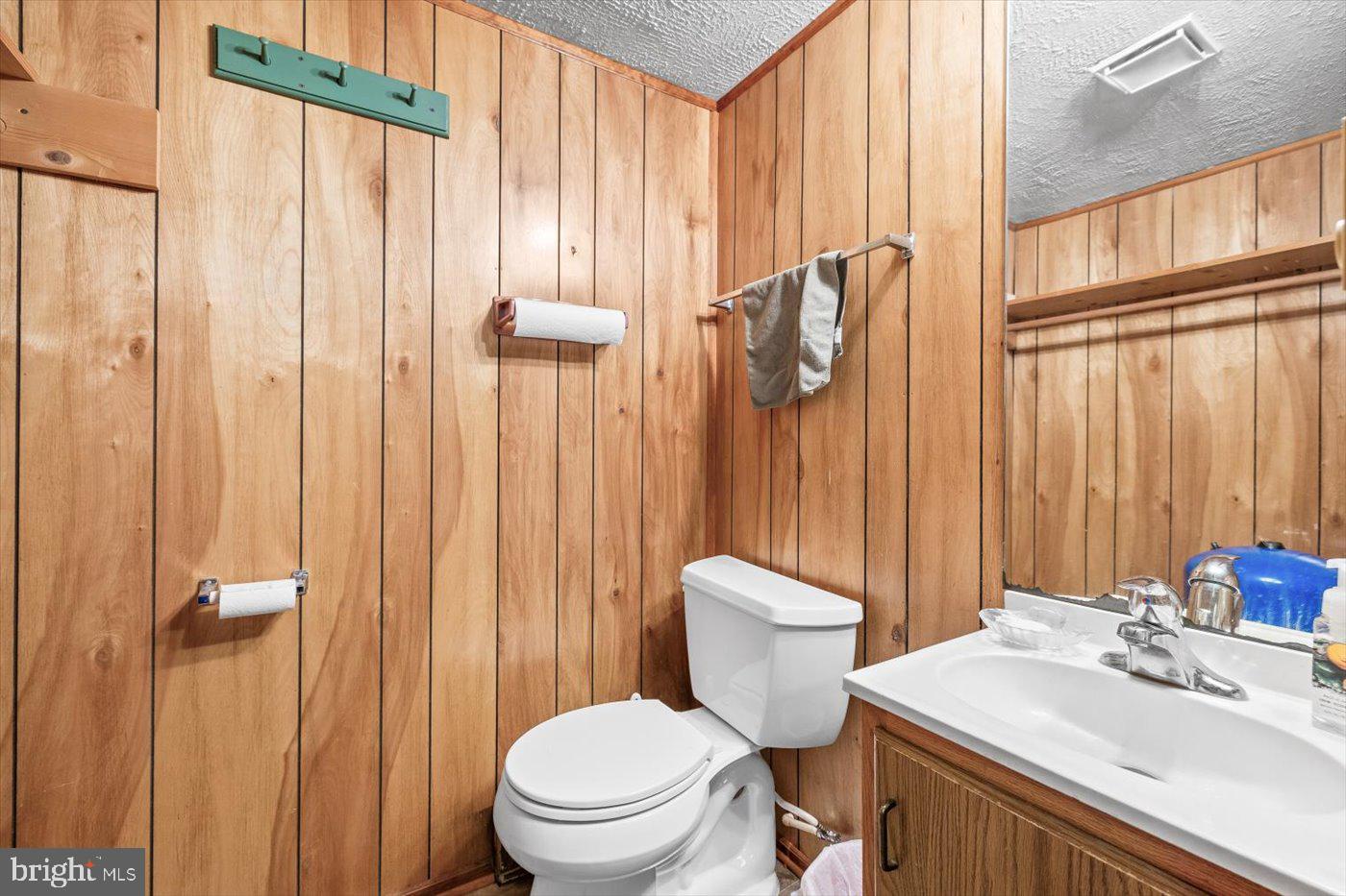 110 Longfield Road Colonial Beach, VA 22443 - Photo 22 of 40 a bathroom with a sink a toilet and shower curtain