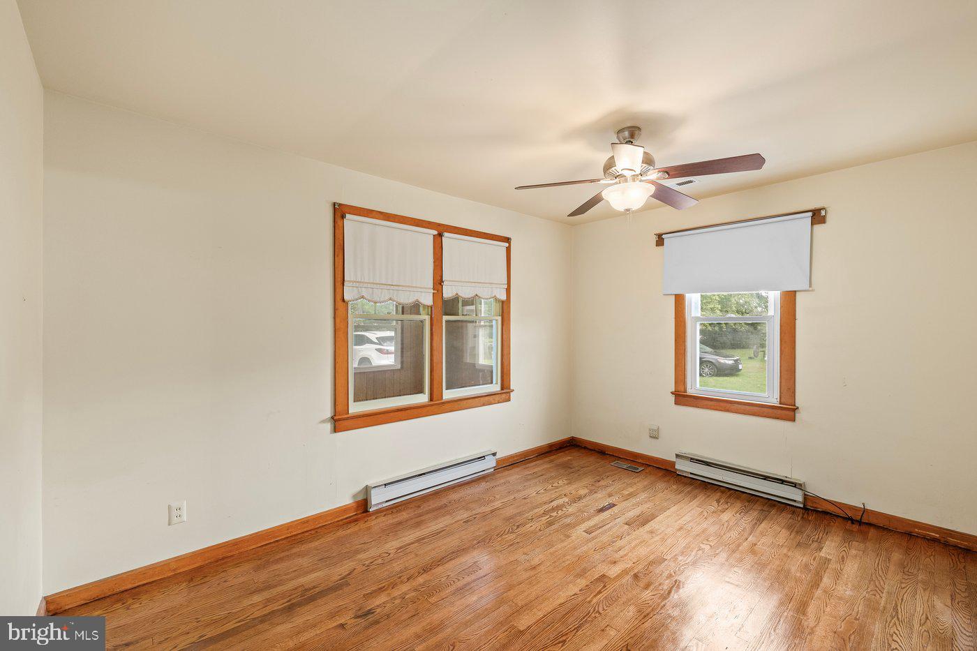 110 Longfield Road Colonial Beach, VA 22443 - Photo 23 of 40 an empty room with wooden floor chandelier fan and windows