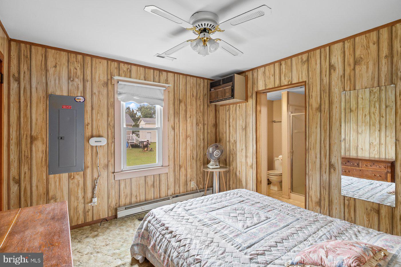 110 Longfield Road Colonial Beach, VA 22443 - Photo 25 of 40 a bedroom with a bed and a chandelier
