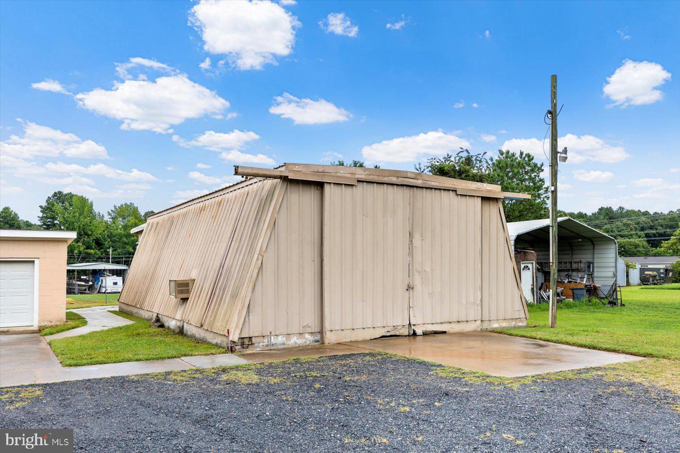110 Longfield Road Colonial Beach, VA 22443 - Photo 34 of 40 a view of a house with backyard and a garden