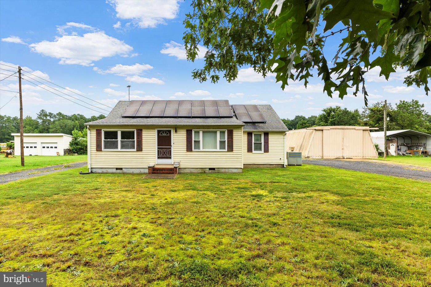 110 Longfield Road Colonial Beach, VA 22443 - Photo 5 of 40 a front view of a house with a garden