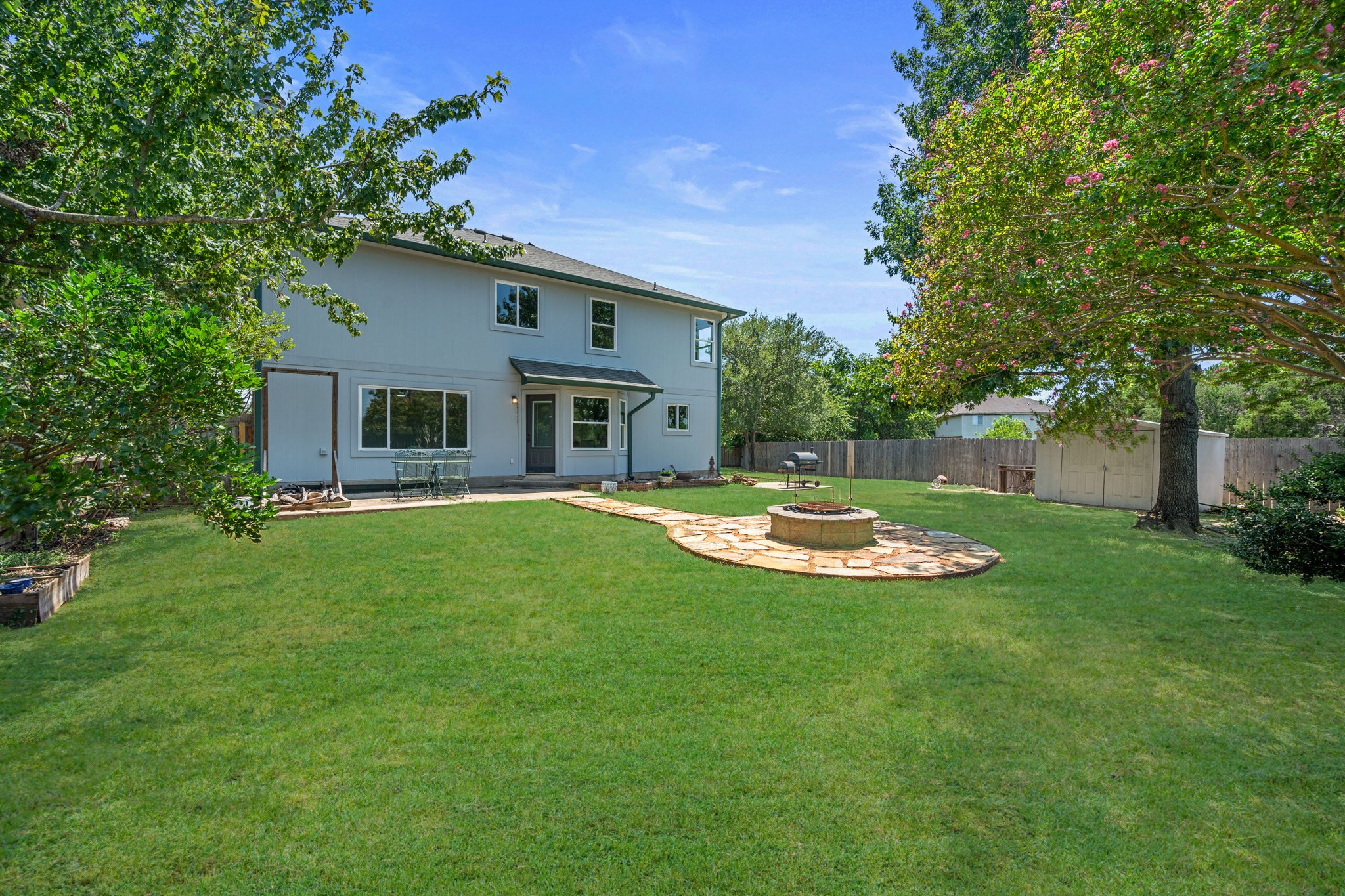 2440 Madeline Loop Cedar Park, TX 78613 - Photo 29 of 33 Back of property featuring a fire pit, a patio area, a storage shed, and a fenced backyard
