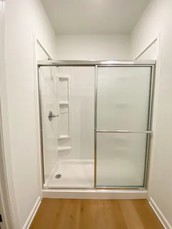 a bathroom with a glass shower door