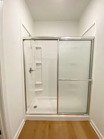 a bathroom with a glass shower door