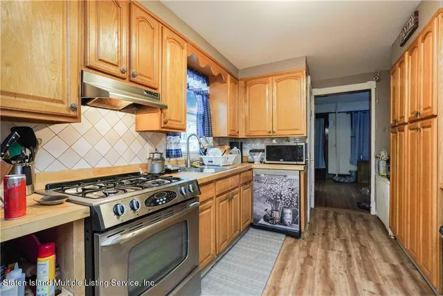 a kitchen with stainless steel appliances granite countertop a stove and a refrigerator