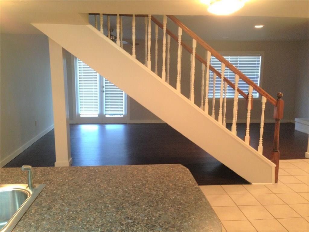 1720 Stonegate Drive Denton, TX 76205 - Photo 8 of 16 a view of staircase with railing and white walls