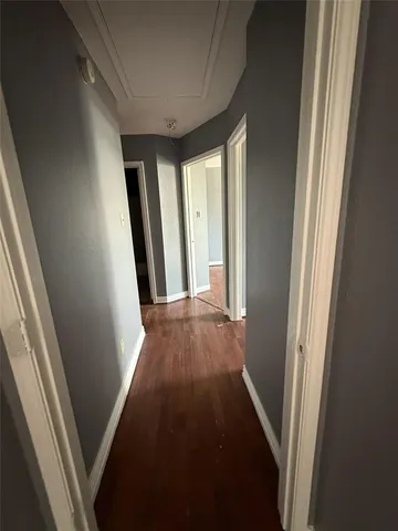 a view of hallway with wooden floor