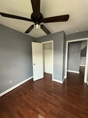 a view of an empty room and wooden floor
