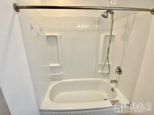 a bathroom with a shower and a bath tub