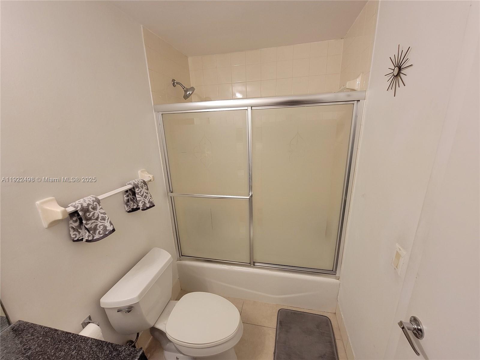 185 Southeast 14th Terrace, Unit 1101 Miami, FL 33131 - Photo 11 of 19 a white toilet sitting next to a bathroom sink