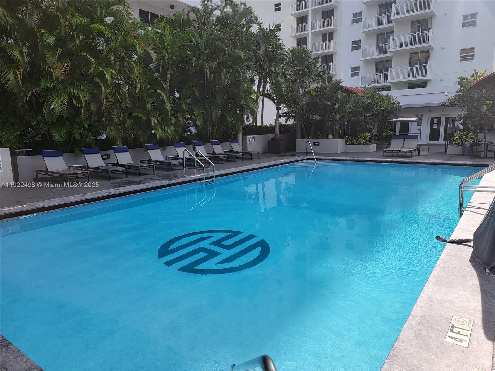 185 Southeast 14th Terrace, Unit 1101 Miami, FL 33131 - Photo 16 of 19 a view of swimming pool with outdoor seating and plants