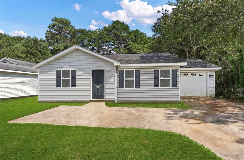 445 Hollow Ridge Drive Athens, GA 30607 - Photo 1 of 1 a front view of a house with a garden and yard