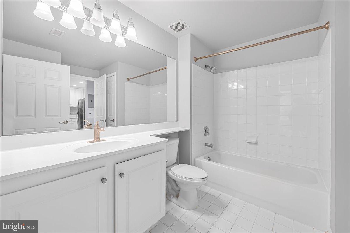11710 Old Georgetown Road, Unit 121 North Bethesda, MD 20852 - Photo 15 of 35 a bathroom with a sink a toilet and shower