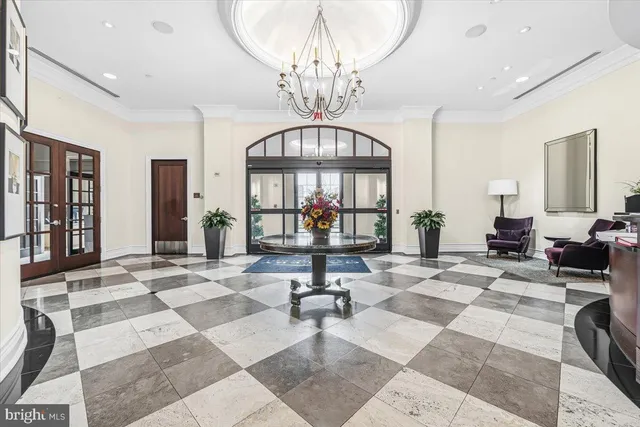 a living room with furniture and a chandelier