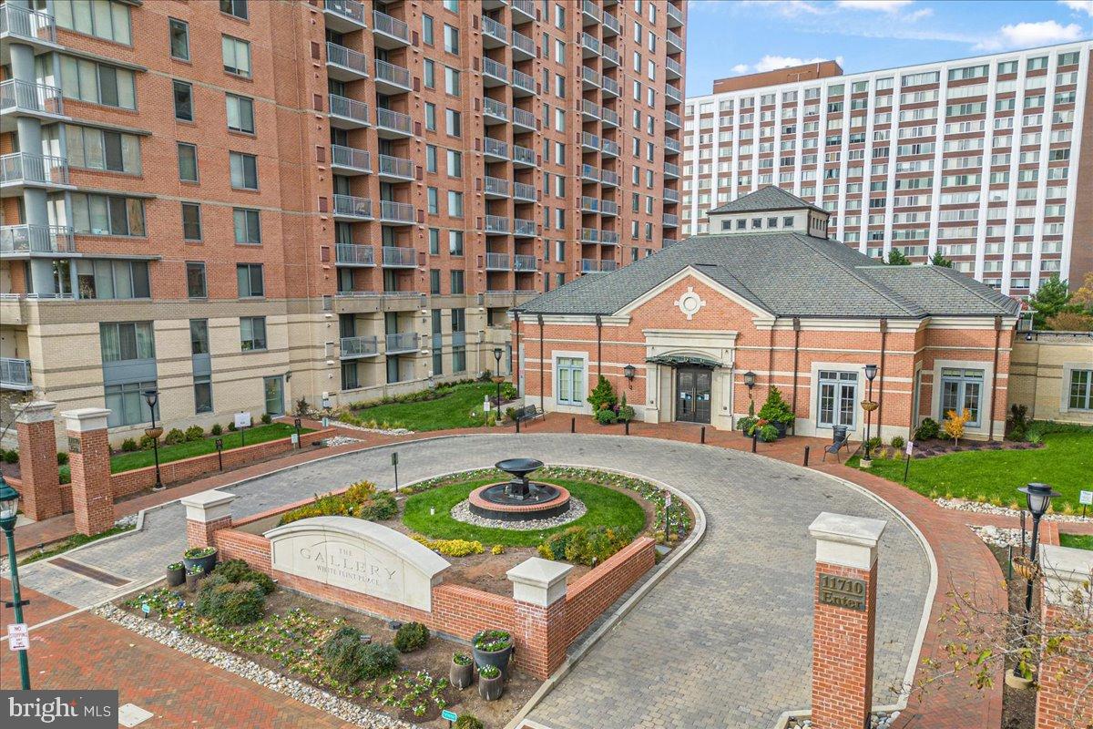11710 Old Georgetown Road, Unit 121 North Bethesda, MD 20852 - Photo 5 of 35 a front view of a building with a garden
