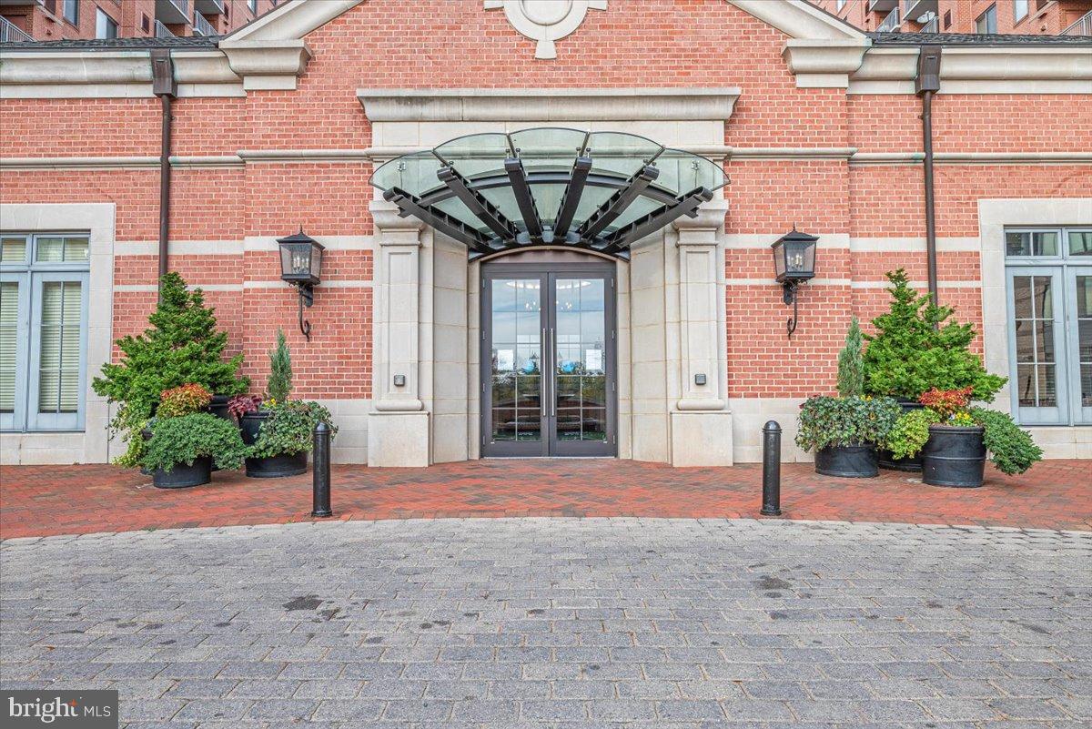 11710 Old Georgetown Road, Unit 121 North Bethesda, MD 20852 - Photo 6 of 35 a front view of a building with a garden and plants