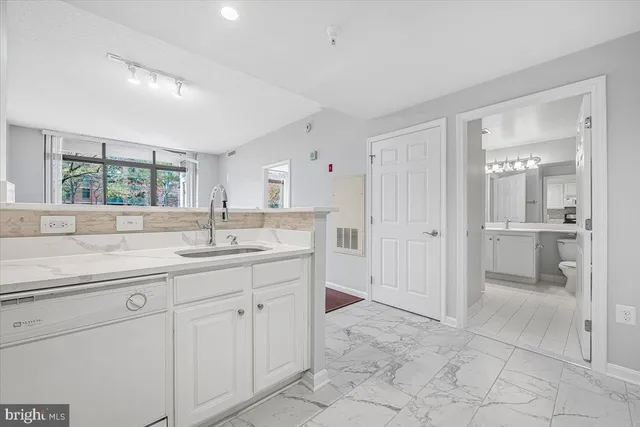 a bathroom with a granite countertop sink mirror and a