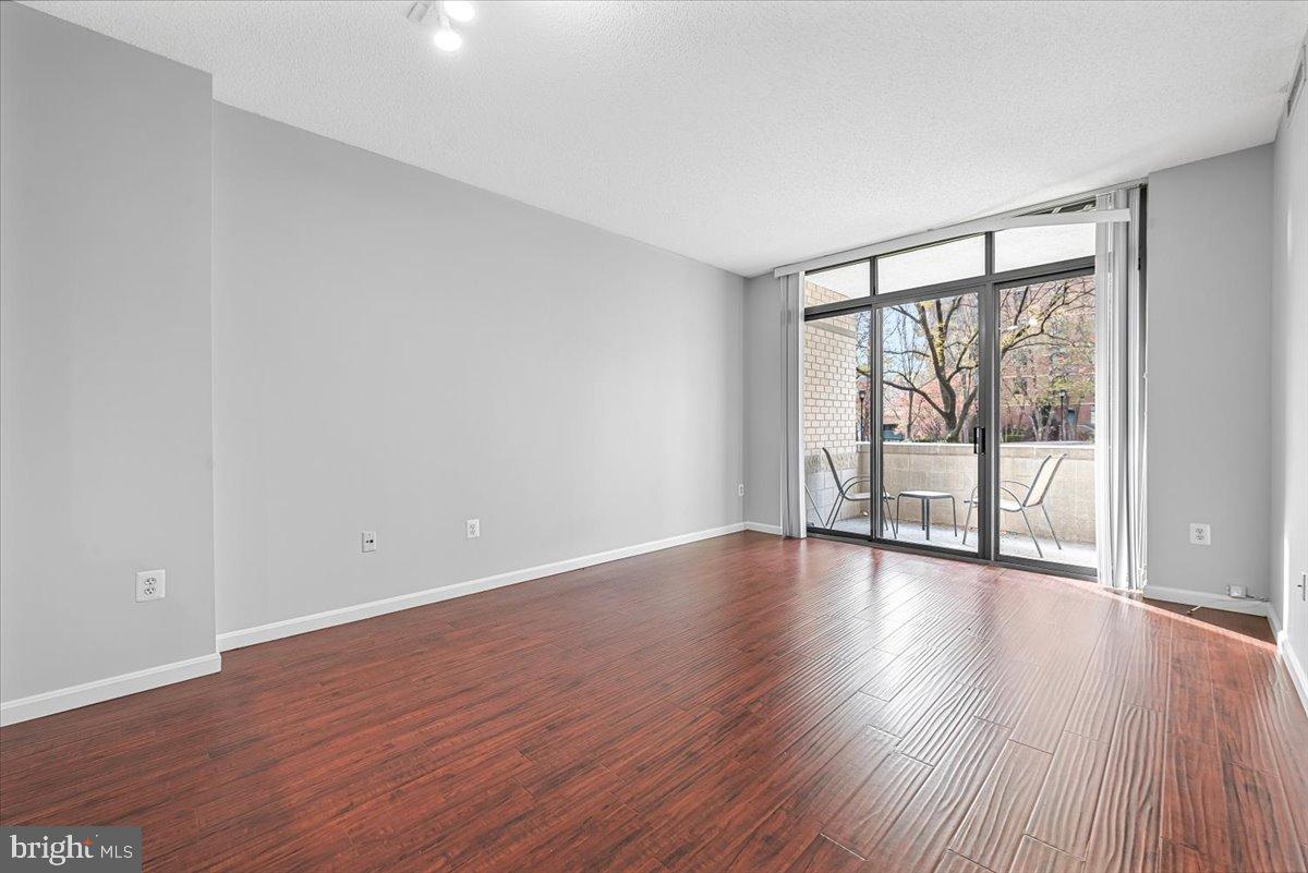 11710 Old Georgetown Road, Unit 121 North Bethesda, MD 20852 - Photo 9 of 35 a view of an empty room with wooden floor and a window