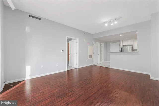 a view of wooden floor and windows in an empty room