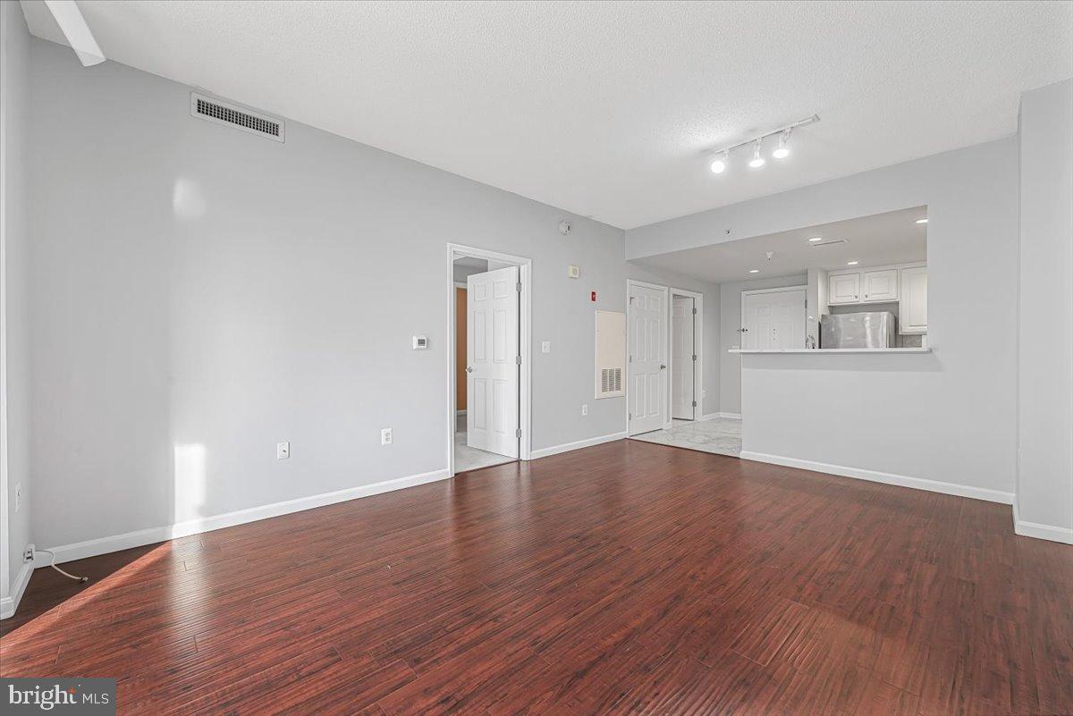 11710 Old Georgetown Road, Unit 121 North Bethesda, MD 20852 - Photo 10 of 35 a view of wooden floor and windows in an empty room