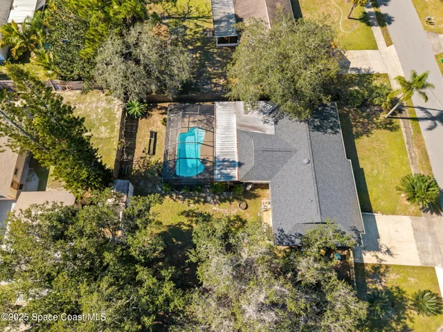 an aerial view of a house with a yard