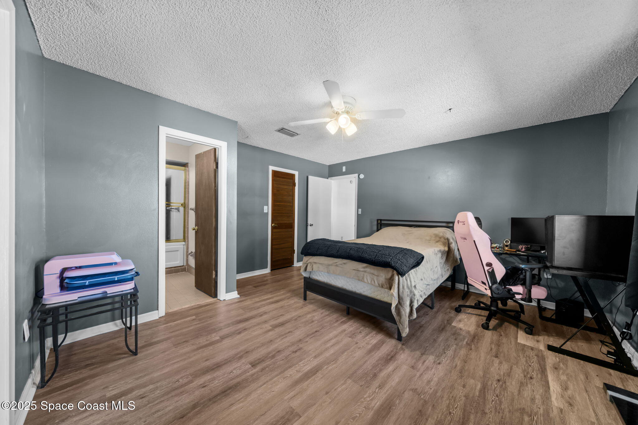 4257 Piedras Street Cocoa, FL 32927 - Photo 11 of 23 a bedroom with a bed and a chandelier