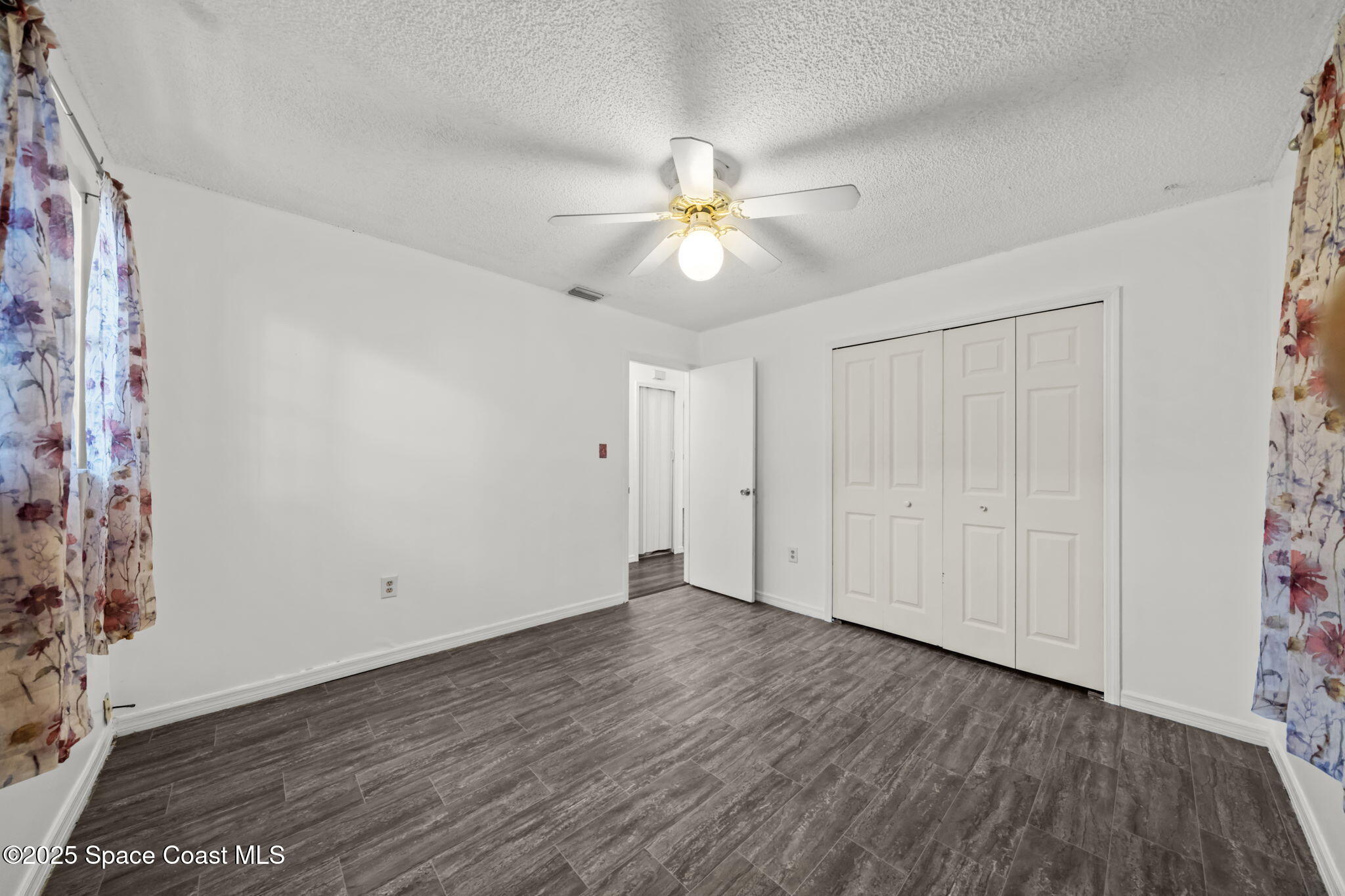 4257 Piedras Street Cocoa, FL 32927 - Photo 13 of 23 a view of an empty room and window a ceiling fan