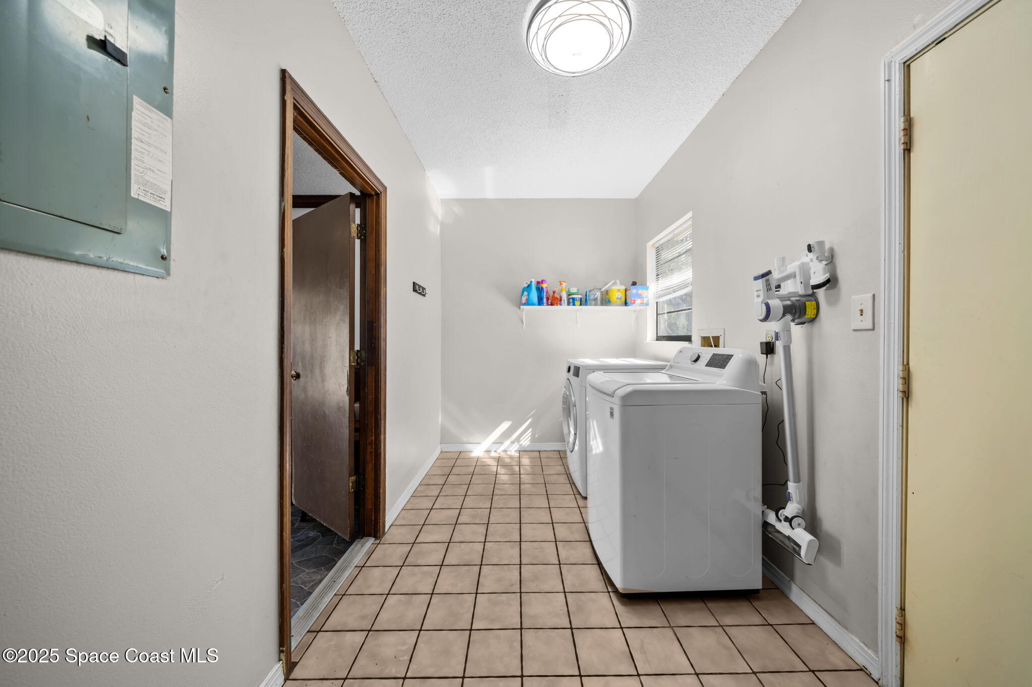 4257 Piedras Street Cocoa, FL 32927 - Photo 19 of 23 a room with water heater and a cabinet