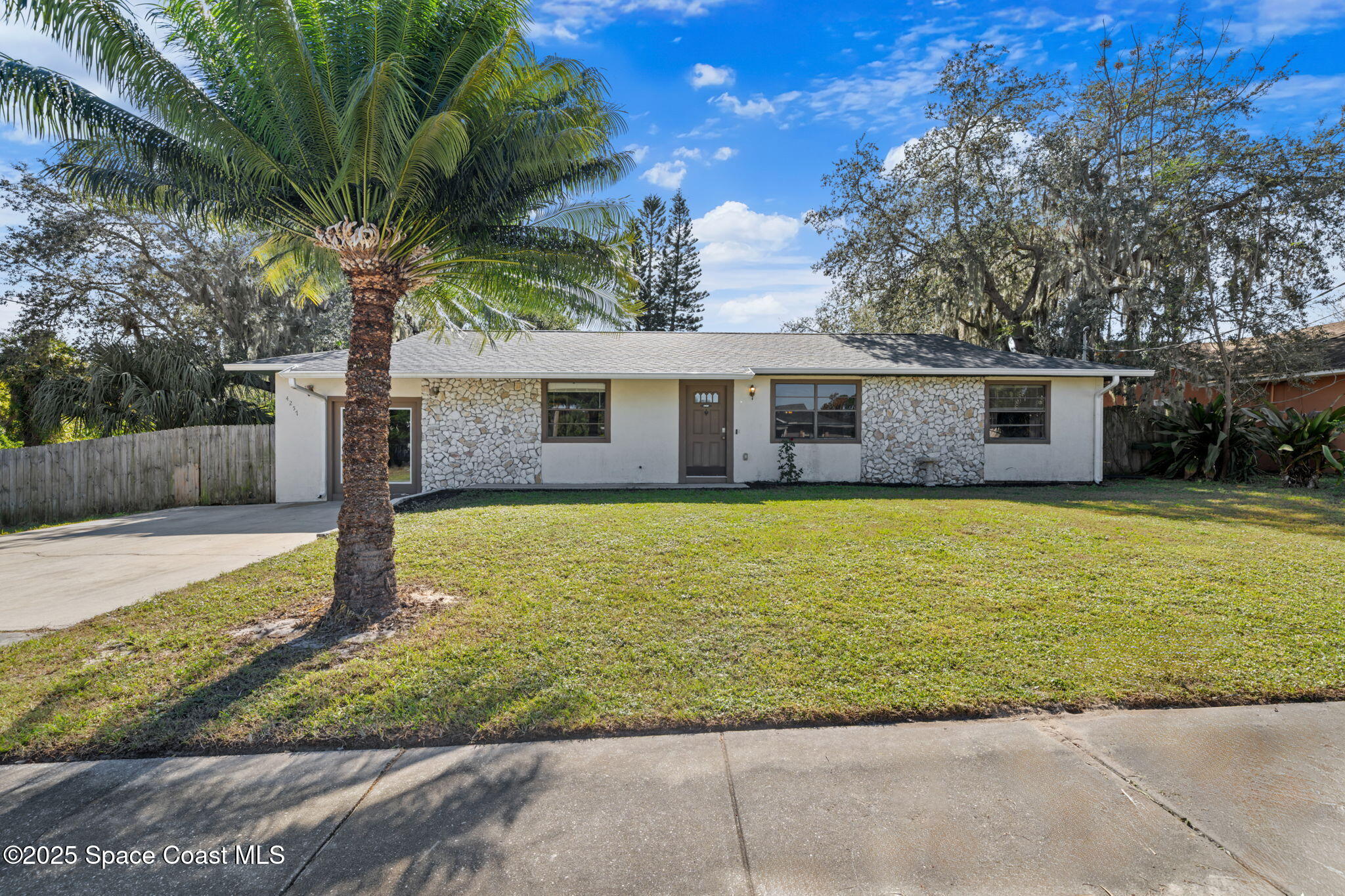 4257 Piedras Street Cocoa, FL 32927 - Photo 3 of 23 a front view of a house with garden